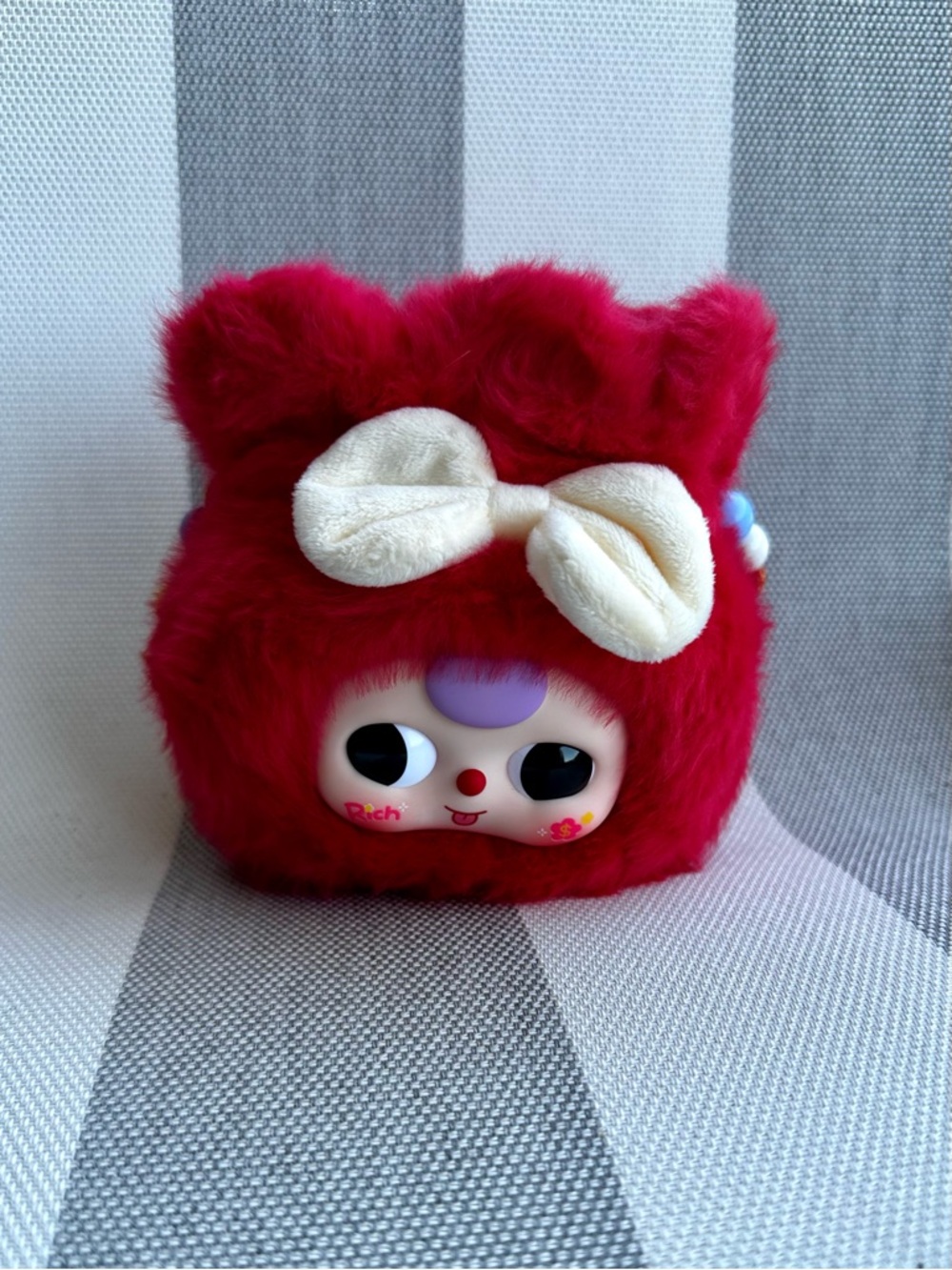 Plush Red Furry Character with Cream Bow